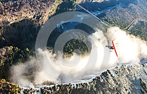 Tourists fly over the Victoria Falls on the trikes.